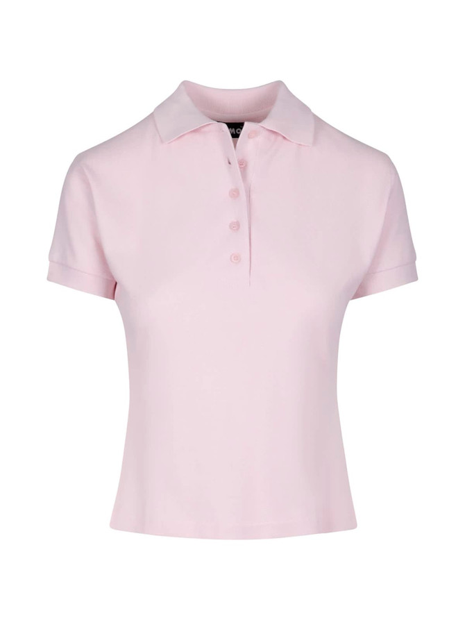 A women's short-sleeved polo shirt in soft pink, featuring a collar and a placket with buttons. It has a logo.