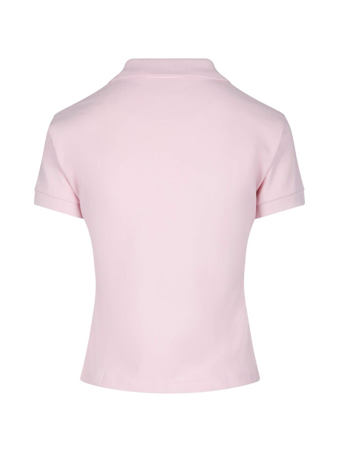 A light pink women's cotton polo shirt with a collar and rolled sleeves. Features a logo on the back.
