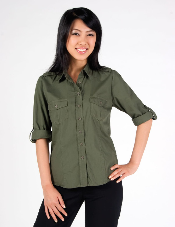 A women's military long sleeve shirt in olive green with button-up front and rolled sleeves. It features two chest pockets and branding.