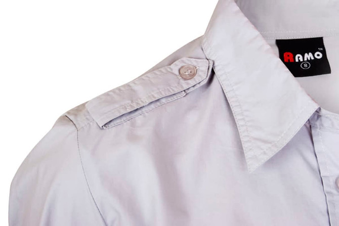 A light grey long sleeve button-up shirt with shoulder epaulets and a logo tag.