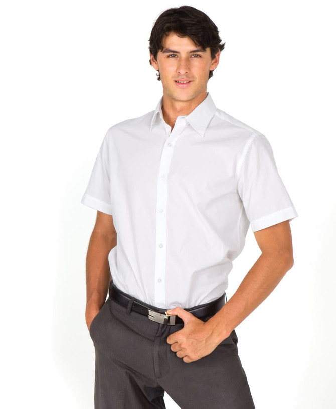 A short-sleeve button-up shirt in white, modelled by a man with dark hair, wearing grey trousers. The shirt features a logo.