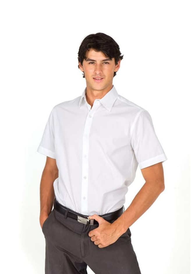 A men's short sleeve button-up shirt in white, featuring a collar and a neat fit, paired with dark trousers.