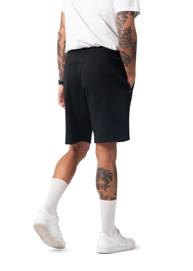 Men's cotton shorts in black, featuring a comfortable waistband and side pockets, displayed from a rear angle.
