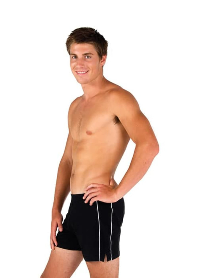 A man in fitted black sports shorts with white detailing, standing sideways against a plain background.