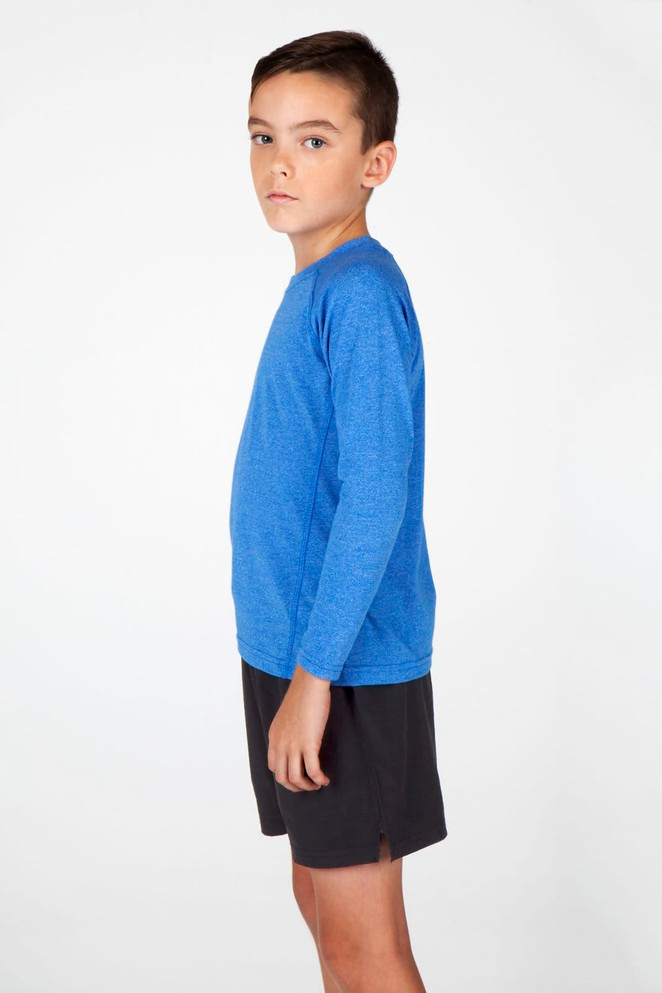 A boy wearing a long-sleeve blue T-shirt and black shorts, facing sideways against a white background.