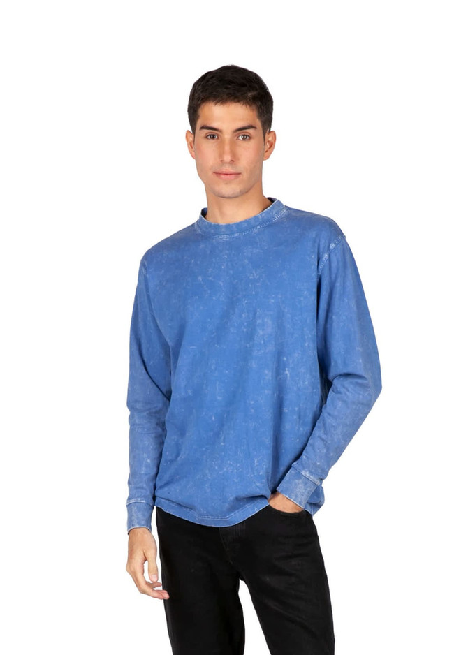 A blue stone wash long sleeve T-shirt worn by a model, featuring a casual fit and a logo on the sleeve.