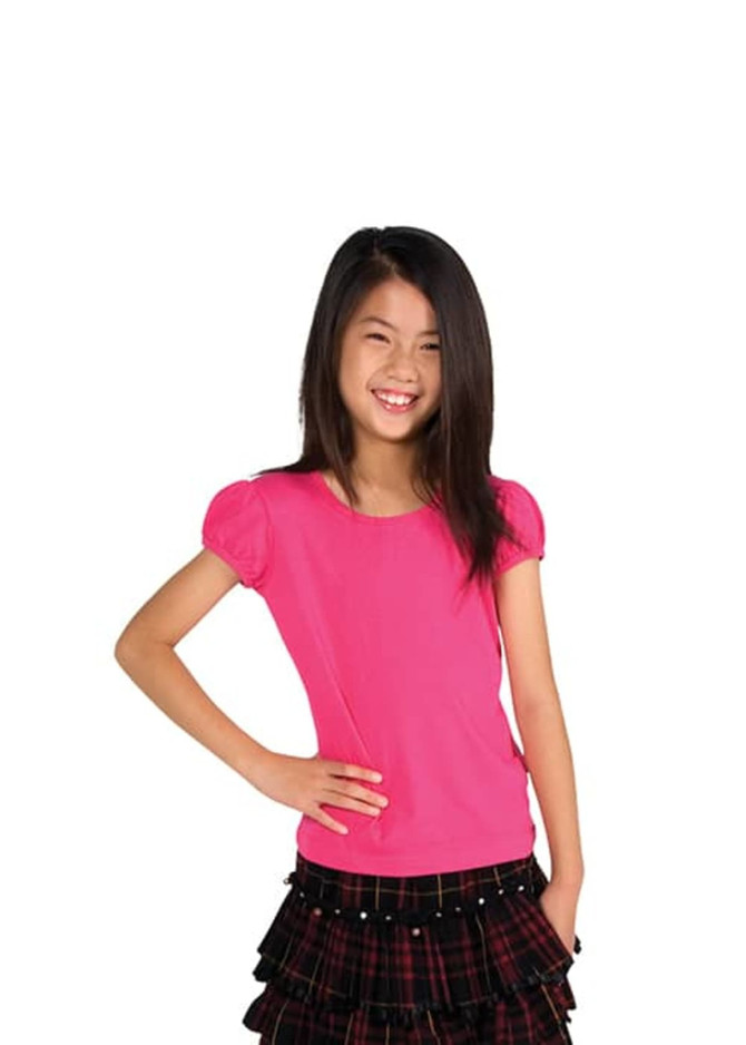A pink short puff sleeve T-shirt paired with a black layered skirt, suitable for girls. The model is smiling.