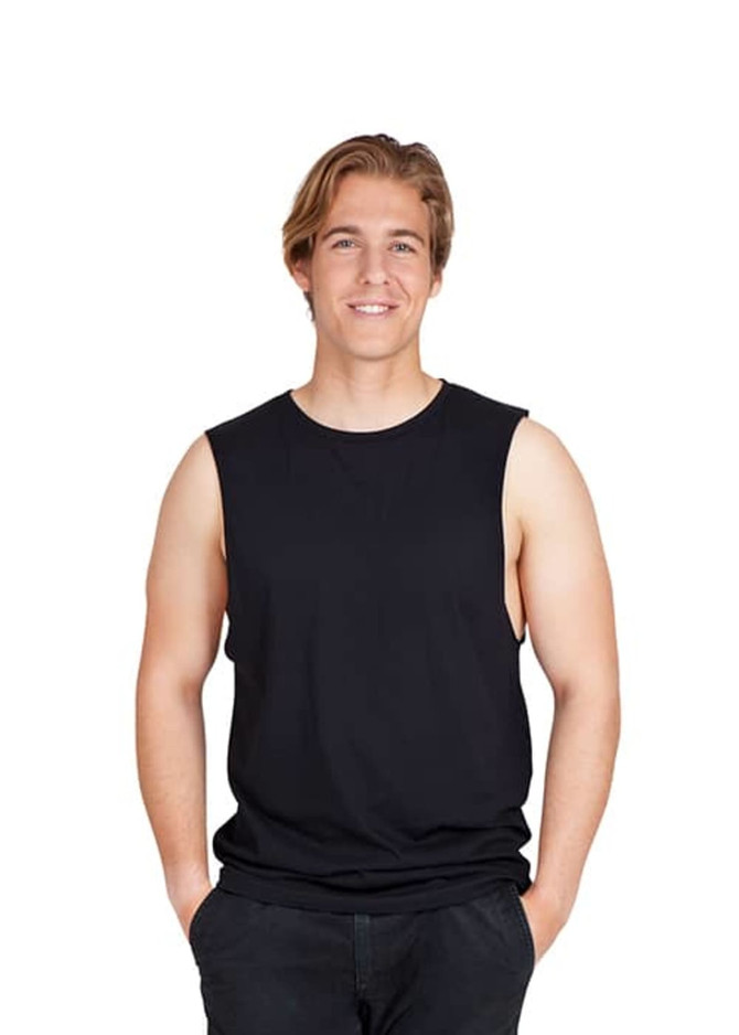 A black unisex combed cotton tank top displayed on a smiling model with hands in pockets.