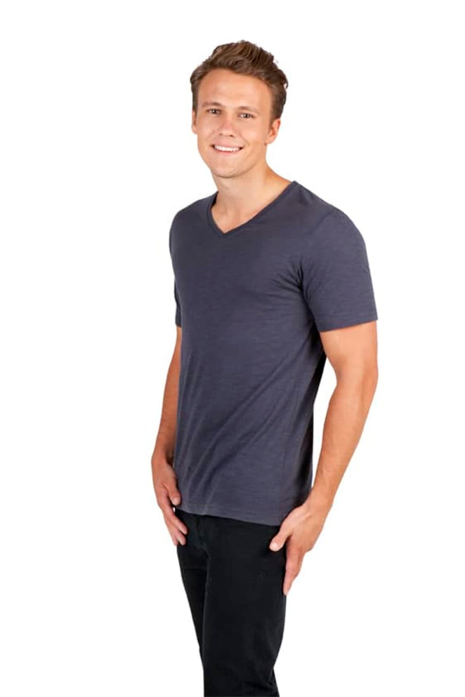 A men's unisex raw cotton v-neck t-shirt in dark grey, featuring a logo. Model shown wearing it.