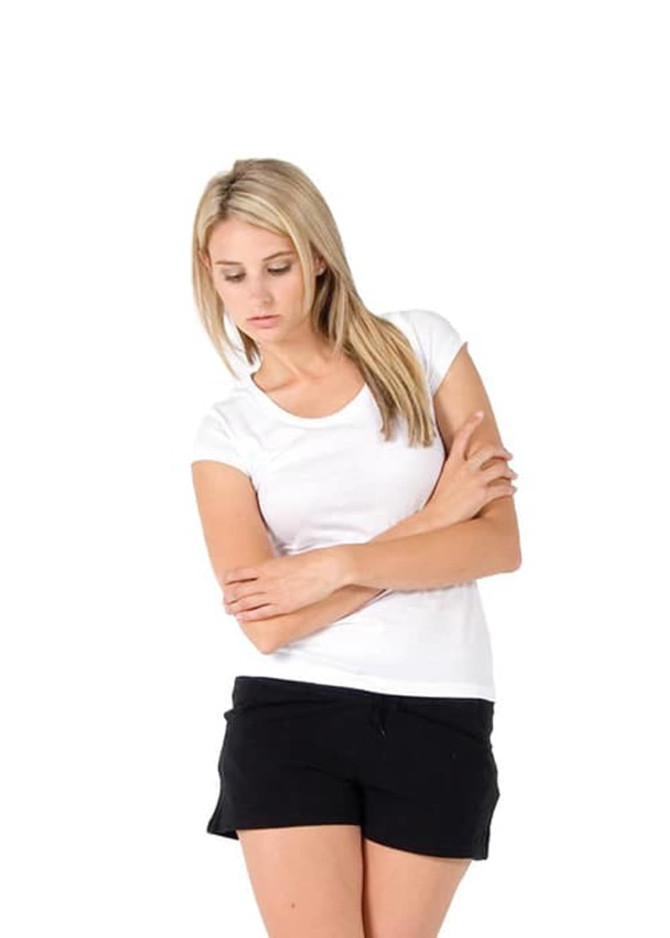 A white women's jersey scoop neck T-shirt displayed on a model wearing black shorts. The model has blonde hair.