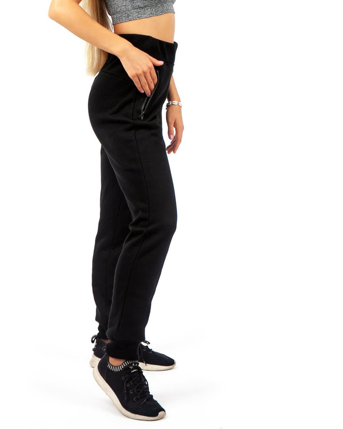Women's black STANCE brushed fleece track pants, featuring a fitted silhouette and side pockets.