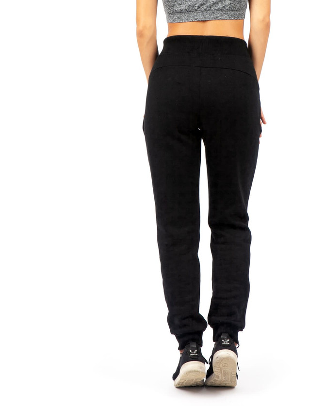 Black brushed fleece track pants for women, featuring a slim fit and elastic waistband, with a logo on the back.