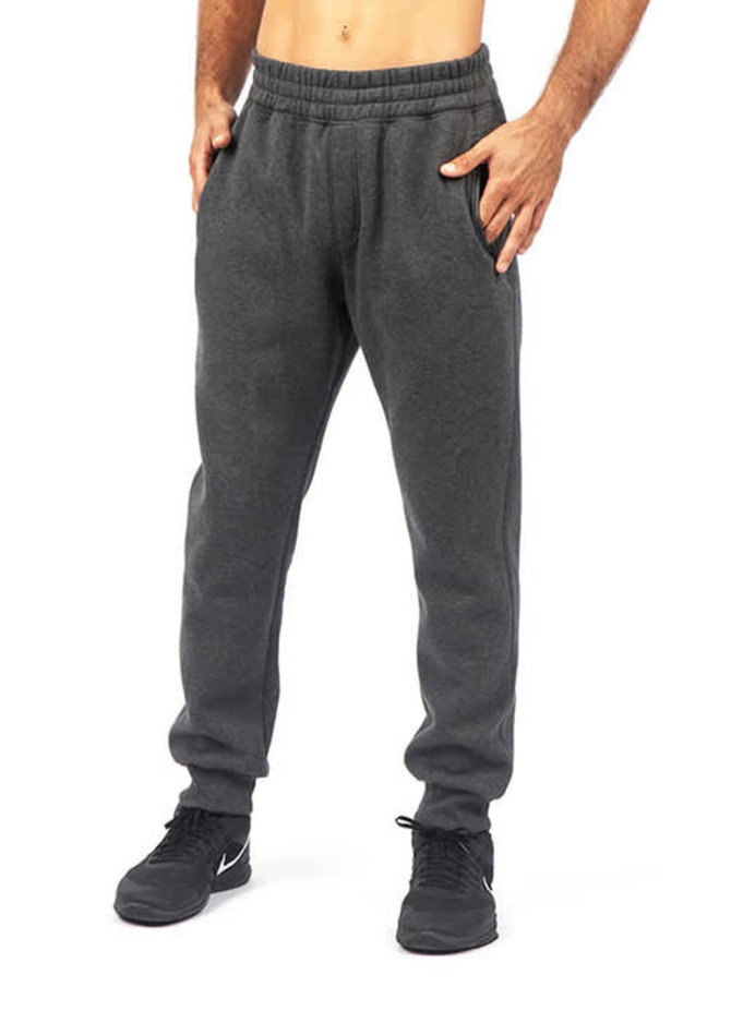 Men's STANCE brushed fleece pants in grey, featuring an elastic waistband and side pockets. The model is wearing black shoes.