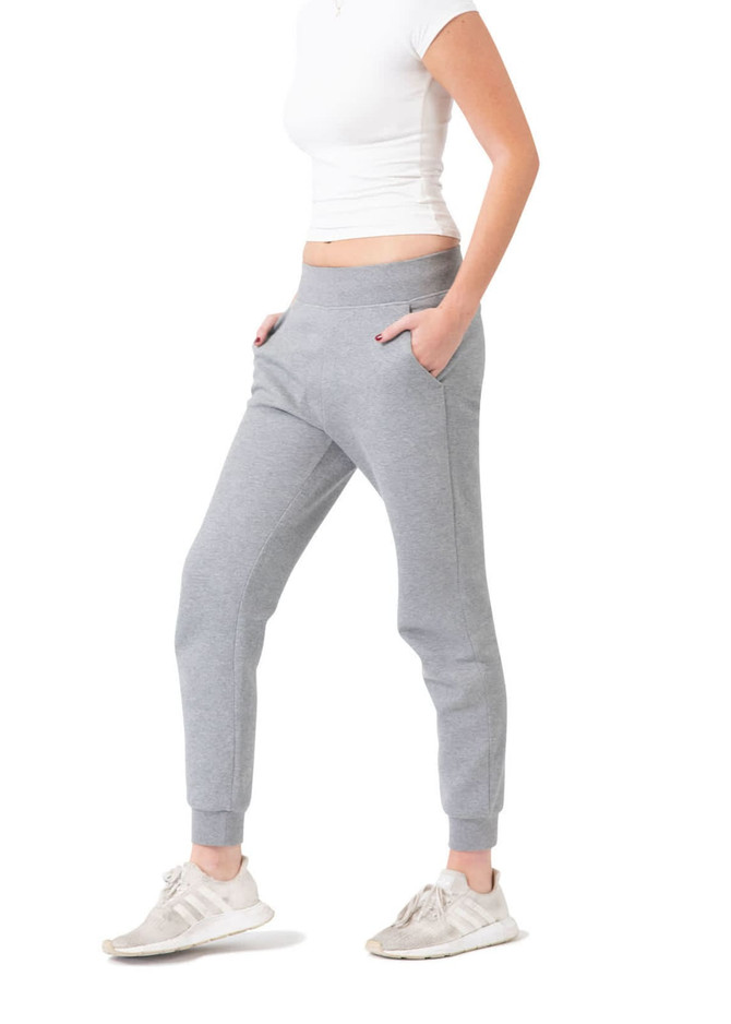 Grey women's track pants with a three-layer design, featuring pockets and a tapered fit.