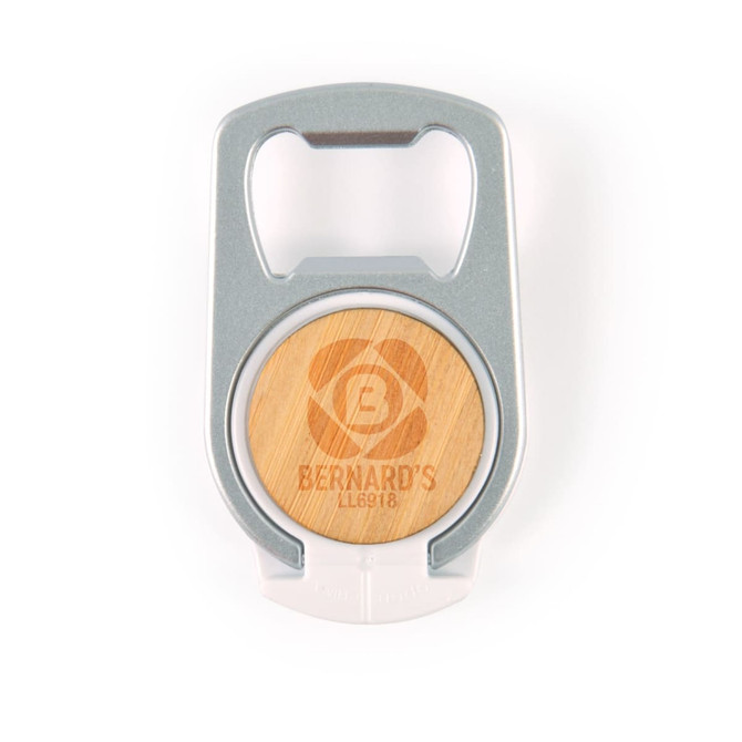 A drink bottle opener phone stand in silver and wood, featuring a circular design with a logo.