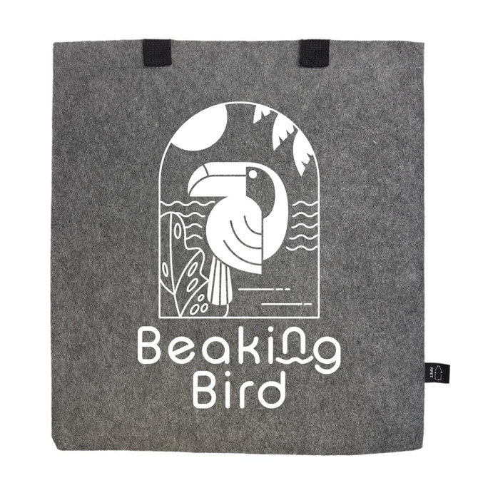 A grey tote bag made of RPET felt features a graphic of a bird and has two black handles, along with a logo.