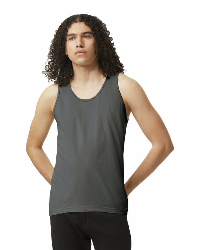 A unisex fine jersey tank in dark grey, featuring a round neckline and a fitted style. The model has curly hair.