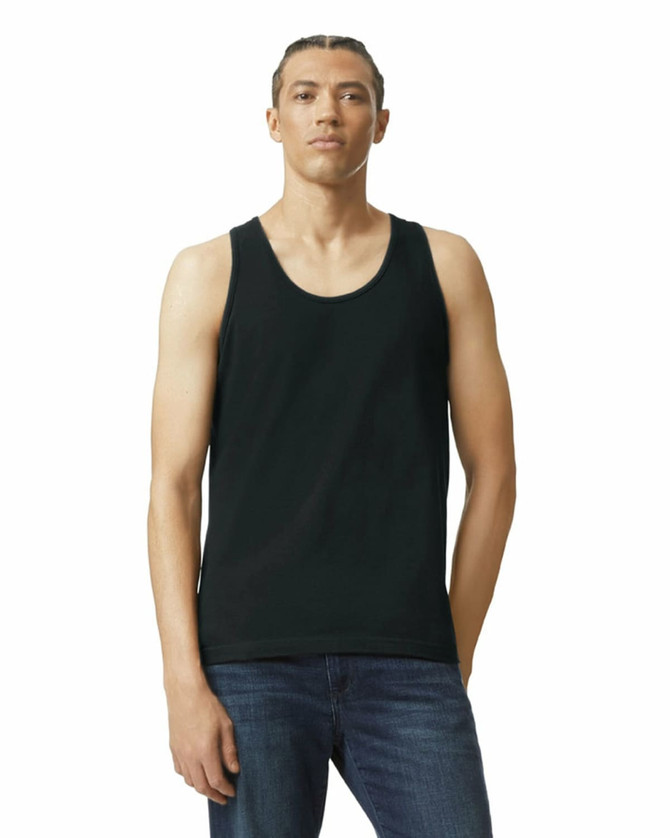 A unisex fine jersey tank in black, featuring a logo, worn by a model with jeans.