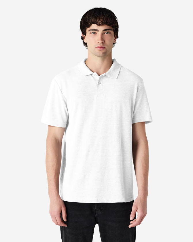 A white short-sleeve polo shirt on a model, featuring a collar and a logo.