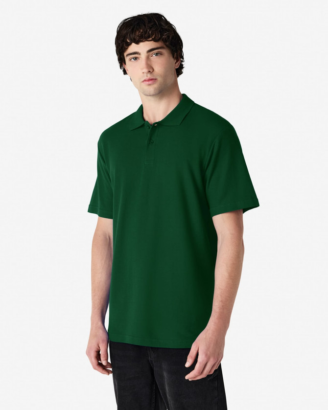 A model wearing a dark green polo shirt with a classic collar and short sleeves, featuring a logo.