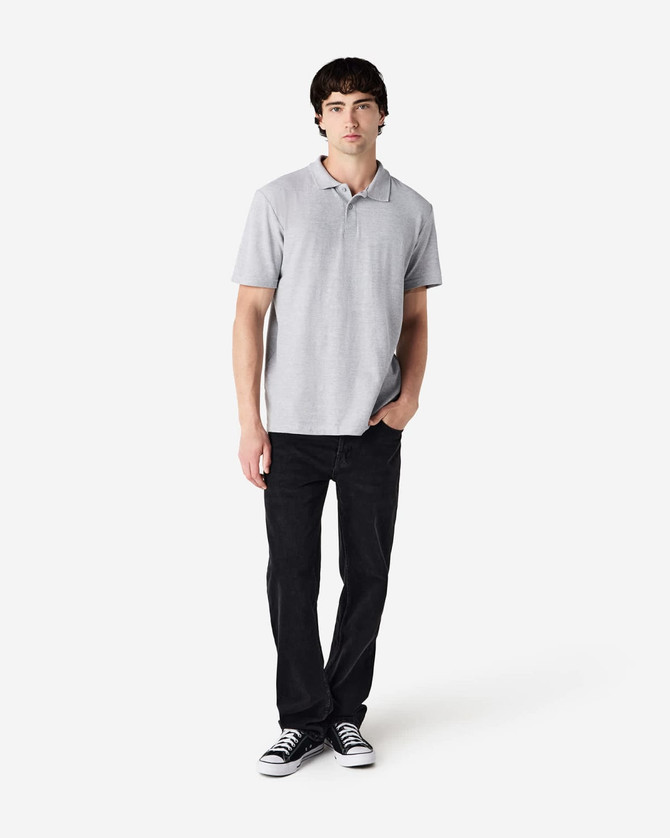 A light grey polo shirt with short sleeves, paired with black trousers and casual shoes. The shirt features a logo.