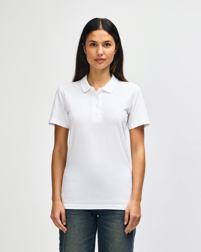 A woman wearing a white Gildan Softstyle Ladies' Double Pique Polo with a classic collar. The polo features a logo.