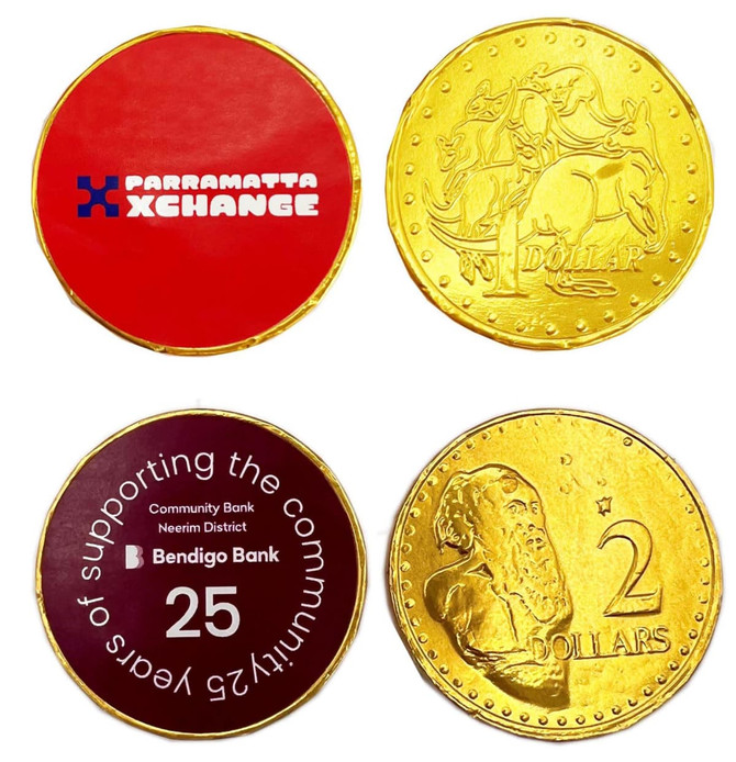 Gold chocolate coins with various designs, including pricing and logos, in a festive arrangement.