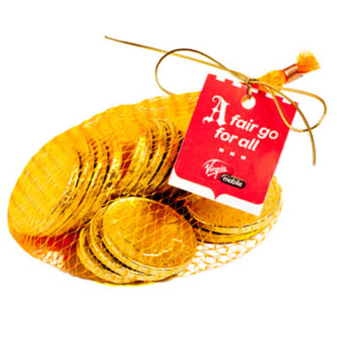 A mesh bag filled with shiny gold chocolate coins, featuring a tag and tied with a golden ribbon.