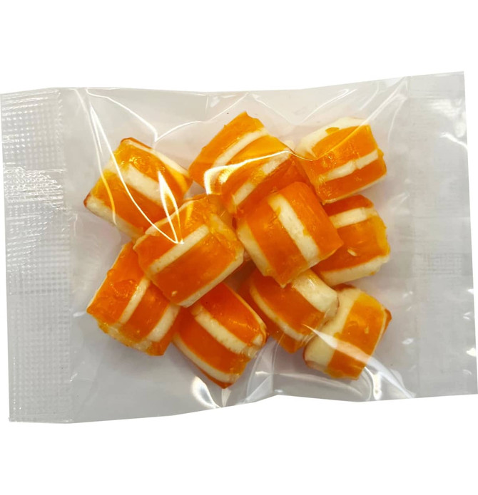 A clear bag containing orange and white striped humbug candies.