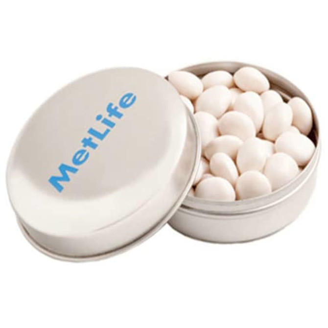 A silver tin filled with white mints, featuring a logo on the lid.