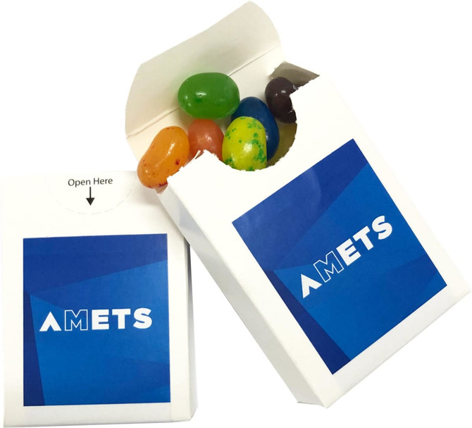 A white flip lid cardboard box filled with multicoloured JELLY BELLY jelly beans and featuring a logo on the front.