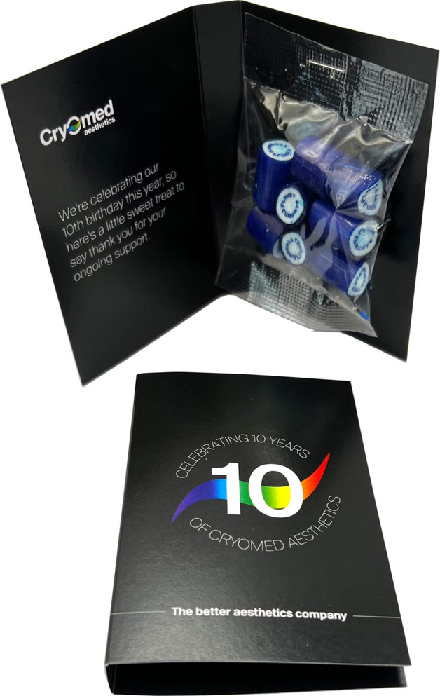 A black promotional card containing blue rock candy pieces, celebrating 10 years of Cryomed Aesthetics.