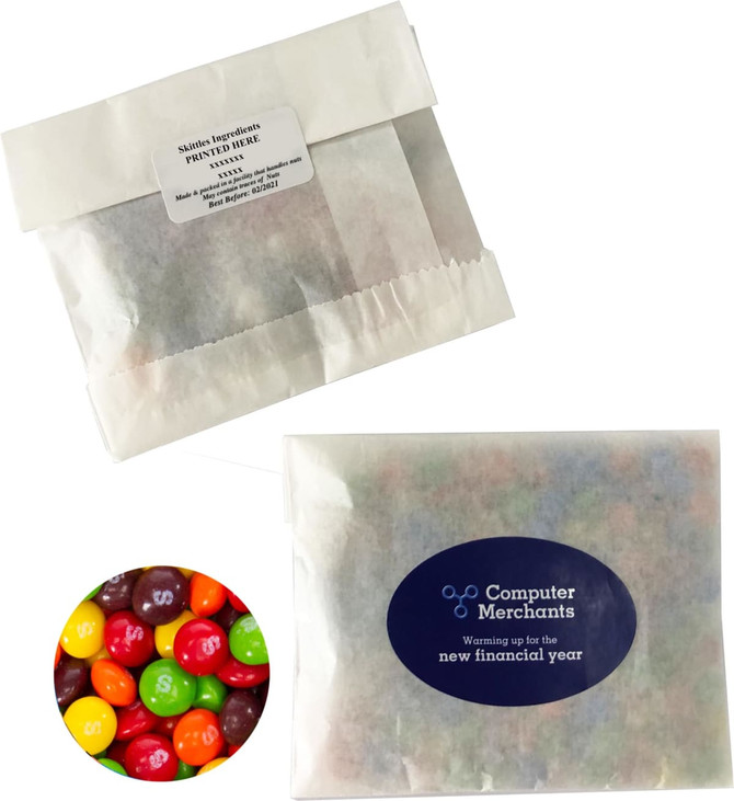 A kraft paper bag containing 50g of colourful Skittles, with a logo on the packaging.