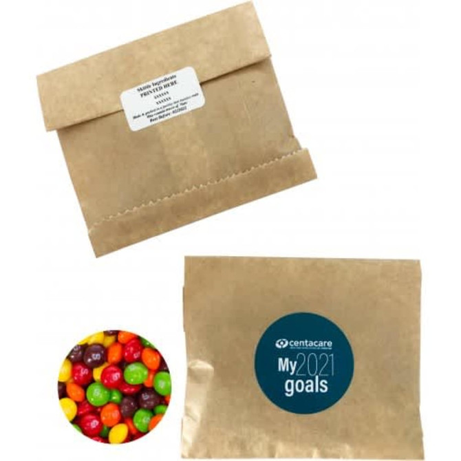 A kraft paper bag filled with colourful Skittles, featuring a logo on the front.