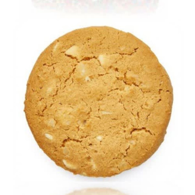 A round, golden-brown cookie featuring white chocolate and macadamia nuts, with a crumbly texture.
