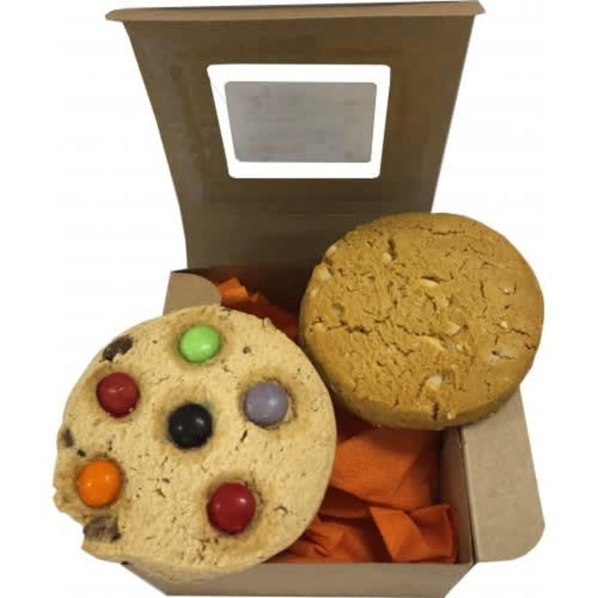 Two cookies in a brown window box, featuring colourful candies on one and a plain golden cookie.