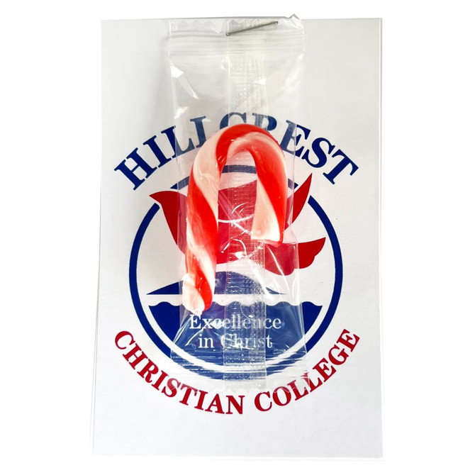 A red and white striped candy cane packaged with a card featuring a logo.