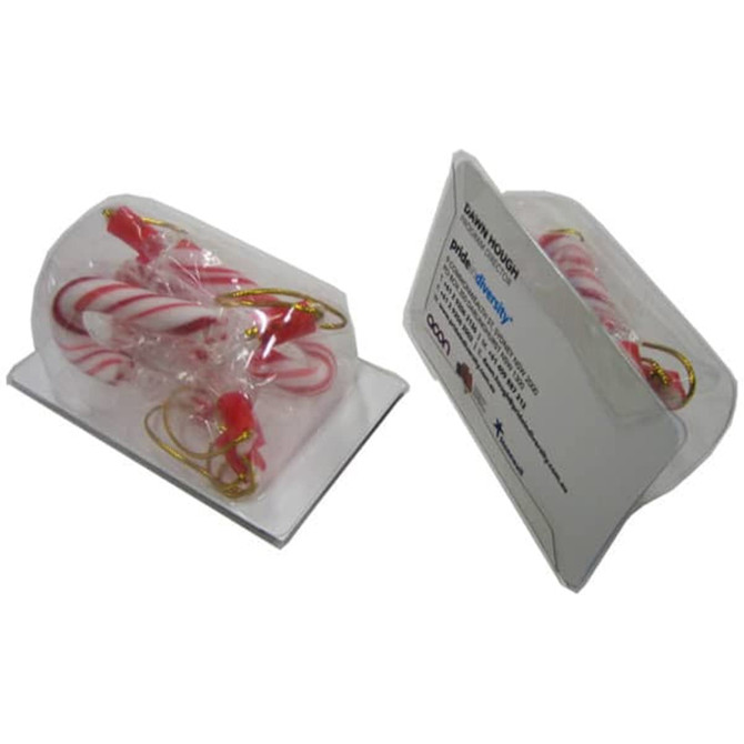 A clear package containing four red and white candy cane-shaped business card holders, featuring a logo on the back.