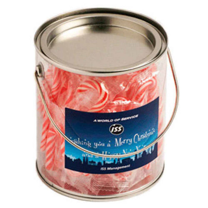 A metallic bucket filled with red and white striped candy canes, featuring a branding label. 