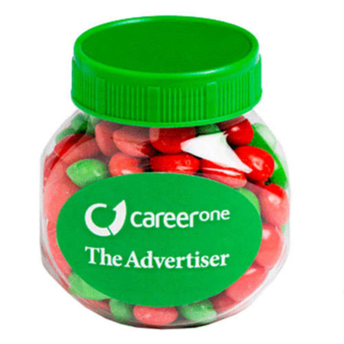 A plastic jar filled with red and green chewy fruit candies. The jar has a green lid and a logo on the front.