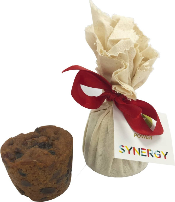 A Christmas pudding wrapped in cream fabric with a red ribbon, accompanied by a small, dark brown pudding.