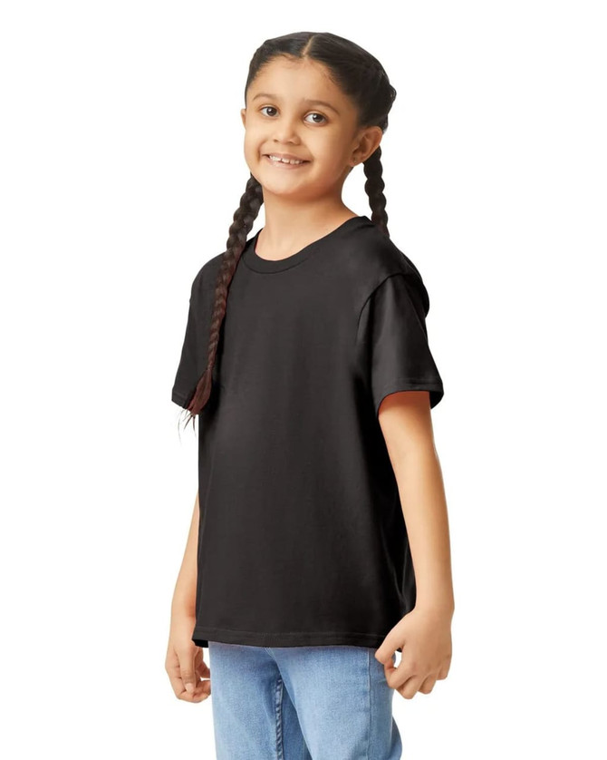 A black Gildan Youth Softstyle short sleeve T-shirt worn by a girl with braids, standing casually.