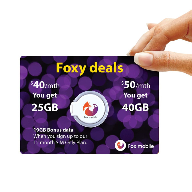 A hand holds a promotional card for Fox mobile plans, featuring a circular phone grip and a purple bokeh background.