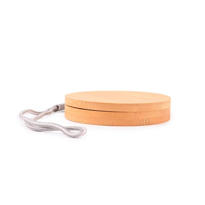 A circular bamboo cable organizer with a textured surface and a grey strap for easy carrying.