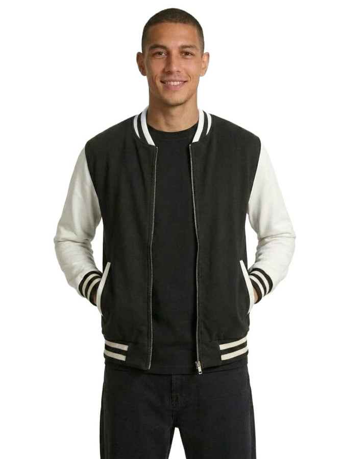 A black and white wool blend varsity jacket with a zip front, ribbed collar, and pockets, worn by a model.