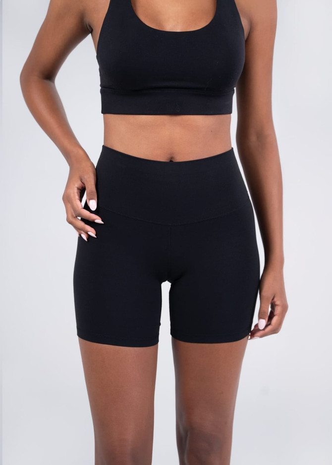 High rise legging shorts in black, featuring a smooth waistband and a fitted design. Includes a logo.
