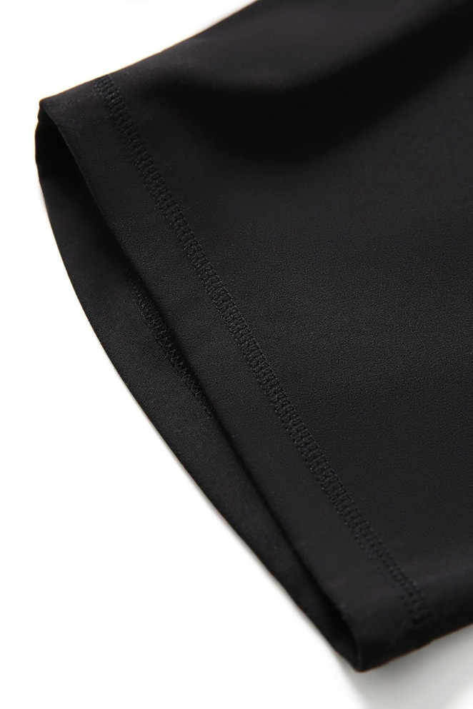 A close-up of black women's high rise legging shorts showing the smooth fabric and stitching detail.