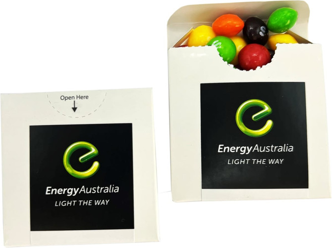 A flip lid cardboard box containing a mix of colourful Skittles lollies with a logo on the front.