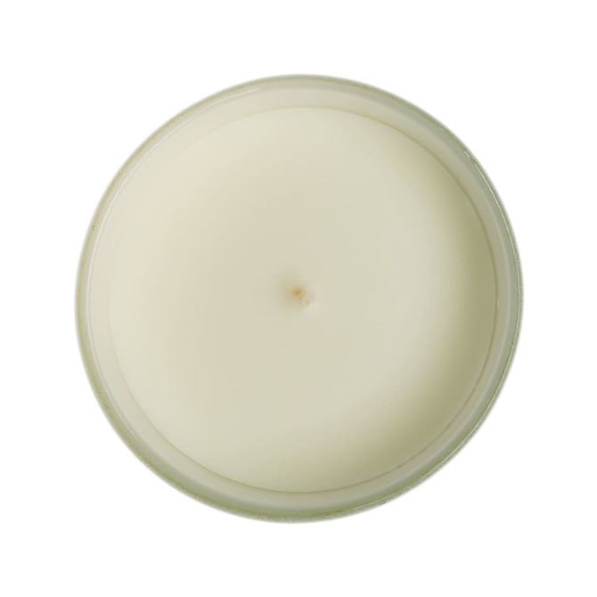 A medium-sized glass candle with a smooth, white wax surface and a single wick at the center.