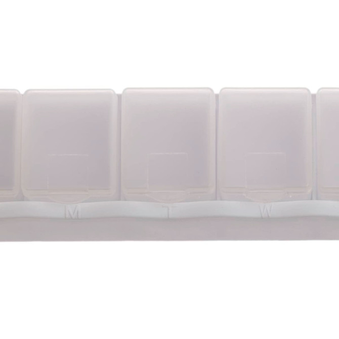A weekly pill box in translucent white plastic with compartments labeled for each day of the week.
